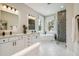 Luxurious bathroom featuring double vanity, freestanding tub, and glass-enclosed shower with designer tile at 6470 Summit View Dr, Brooksville, FL 34601