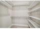 Walk-in closet with white shelving, providing ample storage space and organization at 6470 Summit View Dr, Brooksville, FL 34601