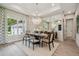 Elegant dining room with stylish chandelier, large windows, and seating for six at 6470 Summit View Dr, Brooksville, FL 34601