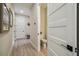 Hallway featuring hardwood floors, modern doors, and easy access to a powder room at 6470 Summit View Dr, Brooksville, FL 34601