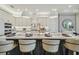 Modern kitchen island features stone counters, seating for four, and pendant lighting at 6470 Summit View Dr, Brooksville, FL 34601
