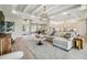 Expansive living room with coffered ceilings, large sectional, and open layout to kitchen at 6470 Summit View Dr, Brooksville, FL 34601