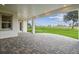 Covered patio overlooking a well-maintained putting green with scenic golf course views at 6470 Summit View Dr, Brooksville, FL 34601