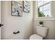 Clean half bathroom featuring contemporary fixtures and tasteful wall art accents at 6470 Summit View Dr, Brooksville, FL 34601