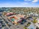 Aerial of complex with beach, pool, ample parking, and colorful buildings at 6800 Sunset Way # 1006, St Pete Beach, FL 33706