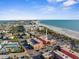 Community aerial showing beach access, buildings, and surrounding neighborhood at 6800 Sunset Way # 1006, St Pete Beach, FL 33706