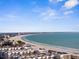 Breathtaking aerial view of the coastline, white sandy beach, and beachfront condos under a bright blue sky at 6800 Sunset Way # 1006, St Pete Beach, FL 33706