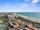 Stunning aerial view capturing the property's prime location near the beach with city views and turquoise waters at 6800 Sunset Way # 1006, St Pete Beach, FL 33706