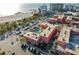Overhead shot featuring a complex with a communal outdoor pool and ample parking by the beach at 6800 Sunset Way # 1006, St Pete Beach, FL 33706