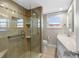 Renovated bathroom with tiled walk-in shower, modern vanity, and bright lighting at 6800 Sunset Way # 1006, St Pete Beach, FL 33706