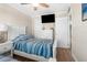 Bright bedroom with coastal decor, wood floors, and multiple storage options at 6800 Sunset Way # 1006, St Pete Beach, FL 33706