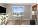 Dining area with table and chairs by window, and a glimpse of the beach at 6800 Sunset Way # 1006, St Pete Beach, FL 33706