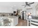 Bright kitchen featuring white cabinets, stainless steel appliances, breakfast bar, and an adjacent dining area at 6800 Sunset Way # 1006, St Pete Beach, FL 33706