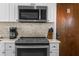 Well-lit kitchen features white cabinets and stainless-steel appliances at 6800 Sunset Way # 1006, St Pete Beach, FL 33706