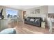 Living room with cozy sofa, dining table, and beach views in distance at 6800 Sunset Way # 1006, St Pete Beach, FL 33706