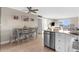 Open-concept living space features a kitchen with stainless steel appliances, breakfast bar and view of the ocean at 6800 Sunset Way # 1006, St Pete Beach, FL 33706