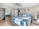 Relaxing main bedroom with nautical decor, large closet, ceiling fan, and ample natural light at 6800 Sunset Way # 1006, St Pete Beach, FL 33706