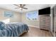 Comfortable main bedroom with a dresser, ceiling fan, a window with a view, and ample natural light at 6800 Sunset Way # 1006, St Pete Beach, FL 33706