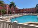 Community swimming pool with lounge chairs for residents in a condominium complex on a sunny day at 6800 Sunset Way # 1006, St Pete Beach, FL 33706