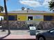 Exterior view of Upham Beach Paradise Grille building with stone and yellow siding at 6800 Sunset Way # 1006, St Pete Beach, FL 33706