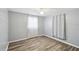 Comfortable bedroom with light wood flooring and a ceiling fan at 7427 Congress St, New Port Richey, FL 34653