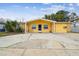 Inviting one-story home featuring a covered front entry and a large driveway for parking at 7427 Congress St, New Port Richey, FL 34653