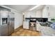 Well-lit kitchen featuring granite countertops, stainless appliances, and ample cabinet space at 7427 Congress St, New Port Richey, FL 34653