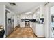 Bright kitchen with stainless steel appliances, white cabinets and tile flooring at 7427 Congress St, New Port Richey, FL 34653