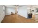 Open-concept living area with laminate floors connecting to the kitchen at 7427 Congress St, New Port Richey, FL 34653