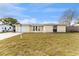 Charming single-story home with an attached garage and a well-maintained lawn in a residential neighborhood at 7610 Ilex Dr, Port Richey, FL 34668