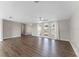 Large living area showcasing wood-look flooring and multiple windows providing abundant natural light at 7610 Ilex Dr, Port Richey, FL 34668