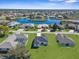 Aerial shot of a residential area featuring serene pond, lush vegetation, and beautiful homes at 8338 Maybelle Dr, Weeki Wachee, FL 34613