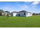 Well-maintained backyard with green lawn and view of the home's exterior at 8338 Maybelle Dr, Weeki Wachee, FL 34613