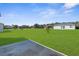 Expansive backyard featuring a large lawn and clear views of neighboring houses at 8338 Maybelle Dr, Weeki Wachee, FL 34613