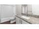 Bathroom with granite counter, white cabinets, shower and bathtub at 8338 Maybelle Dr, Weeki Wachee, FL 34613