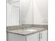 Bathroom vanity with double sinks, granite countertop, and framed mirror at 8338 Maybelle Dr, Weeki Wachee, FL 34613