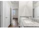 Bathroom with double sink vanity, granite countertop, and view into bedroom at 8338 Maybelle Dr, Weeki Wachee, FL 34613