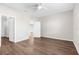 Spacious bedroom with wood-look floors, a ceiling fan, and a convenient en-suite bathroom at 8338 Maybelle Dr, Weeki Wachee, FL 34613