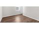 Bedroom with natural light and wood-style laminate flooring at 8338 Maybelle Dr, Weeki Wachee, FL 34613