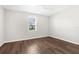 Bright bedroom with wood-look flooring, a ceiling fan, and a window providing natural light at 8338 Maybelle Dr, Weeki Wachee, FL 34613
