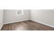 Neutral bedroom with laminate floors, a window and base molding at 8338 Maybelle Dr, Weeki Wachee, FL 34613