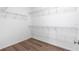 Walk in closet with laminate wood floor and wire shelving at 8338 Maybelle Dr, Weeki Wachee, FL 34613