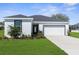 Charming single-story home with lush landscaping, inviting curb appeal and attached garage at 8338 Maybelle Dr, Weeki Wachee, FL 34613