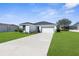 Attractive one-story home with a well-manicured lawn and a spacious driveway at 8338 Maybelle Dr, Weeki Wachee, FL 34613