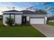 Beautiful single-story home with lush landscaping, appealing curb appeal under a dramatic sunset sky at 8338 Maybelle Dr, Weeki Wachee, FL 34613