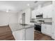 Modern kitchen with granite countertops, stainless steel appliances, and a central island at 8338 Maybelle Dr, Weeki Wachee, FL 34613