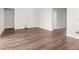 Open living room area with wood-look floors and access to various rooms in the home at 8338 Maybelle Dr, Weeki Wachee, FL 34613