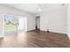 Spacious living room with wood-look floors, sliding glass doors, and plenty of natural light at 8338 Maybelle Dr, Weeki Wachee, FL 34613