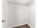 Spacious walk-in closet with shelving and laminate flooring at 8338 Maybelle Dr, Weeki Wachee, FL 34613