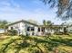 Spacious backyard featuring lush greenery and mature trees providing ample shade at 8404 Winding Wood Dr, Port Richey, FL 34668